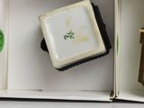 a box with a clock and a cup on top of it