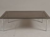 an image of a coffee table with a glass top and chrome legs