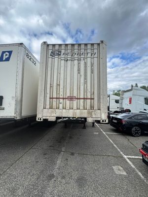 two trucks that are parked in a parking lot
