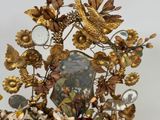 a gold clock with a bird on top of it