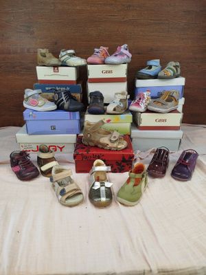 many pairs of shoes sitting on a table with boxes