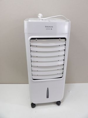 a small white air conditioner sitting on a table