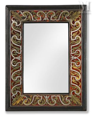 a black and red mirror with a decorative design on it