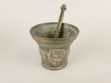 a mortar and a pestula in a metal cup