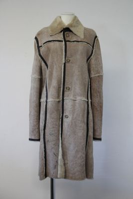 an image of a woman ' s coat on a mannequin stand