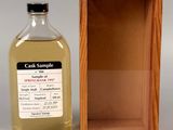 an image of a bottle of alcohol sitting in front of a wooden box