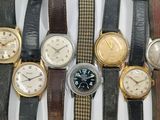 several different types of watches are displayed on a white surface