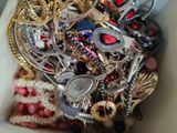 a white box filled with lots of different types of jewelry