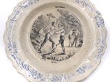 a blue and white plate with a picture of a man and a woman on it