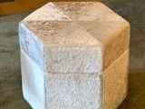 a small stool made out of a cow hider