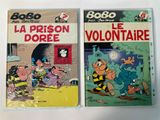 two books on a white surface with a cartoon character on them