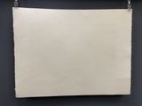 a white piece of paper hanging on a black wall