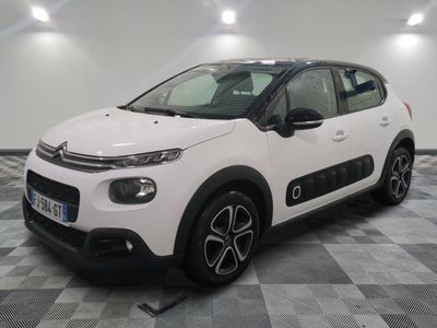 the white citrole is parked on a checkered floor