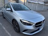 a silver mercedes cla parked in a parking lot