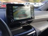 a car dashboard with a monitor on it and a steering wheel