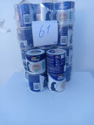 several cans of paint are stacked on top of each other on a table