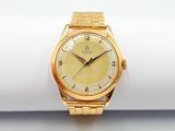 an image of a close up of a gold wrist watch on a napkin
