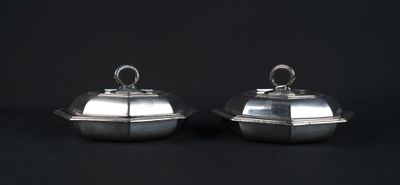 pair of silverplated dishes with lids on black background