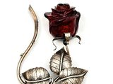 a rose that is sitting on top of a metal object
