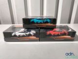 three boxes of hot wheels cars are stacked on top of each other