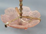 a pink glass bowl with a gold ring on top of it