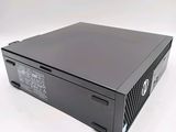 the hp desktop computer is sitting on a white surface