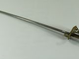 an old sword with a wooden handle on a white surface
