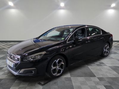 the black car is parked in the garage on a checkered floor