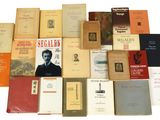 a lot of books that are stacked together on a table