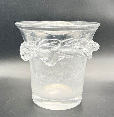 a clear glass vase with a flower design on it