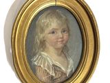 portrait of a young girl in a gold frame with blue eyes