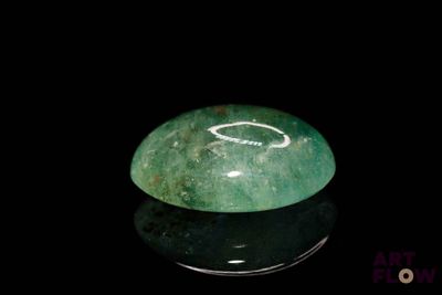 an image of a green jade stone on a black surface