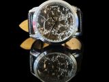 a close up of a wrist watch on a reflective surface