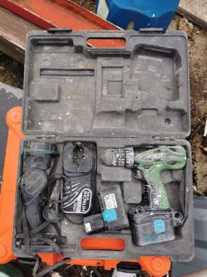 a tool box with tools in it sitting on the ground