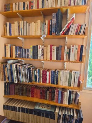 a bookshelf full of books in the corner of the room