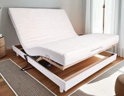 a bed that has a mattress on top of it