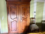 a bedroom with a bed, dresser, and chair in it