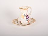 a small cup and saucer sitting on a saucer