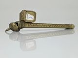 a small metal object with a small clock on it