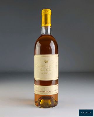 a bottle of wine sitting on top of a white table