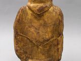 an old wooden figurine of a man with a hat on his head