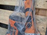 two orange and black tools are wrapped in plastic on a wooden pallet