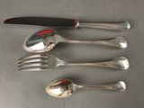 four forks, a knife, and a spoon on a table