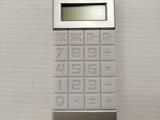 a calculator sitting on a wall in a bathroom