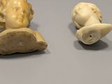 pair of carved ivory figurines of a man and a woman