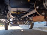 the rear end of a truck with a man standing next to it