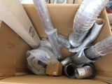 a cardboard box with a bunch of pipes inside of it