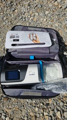 a bag with a cell phone inside of it on the ground