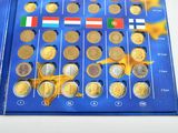 a lot of coins that are on a blue board