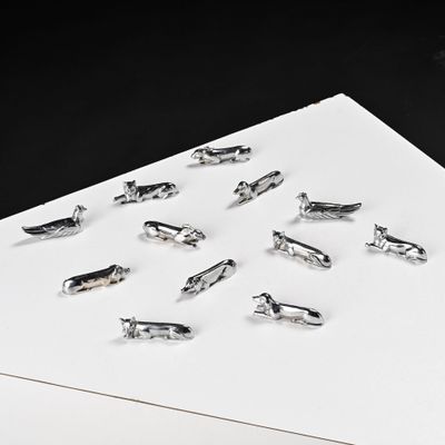 a lot of small silver birds on a piece of paper